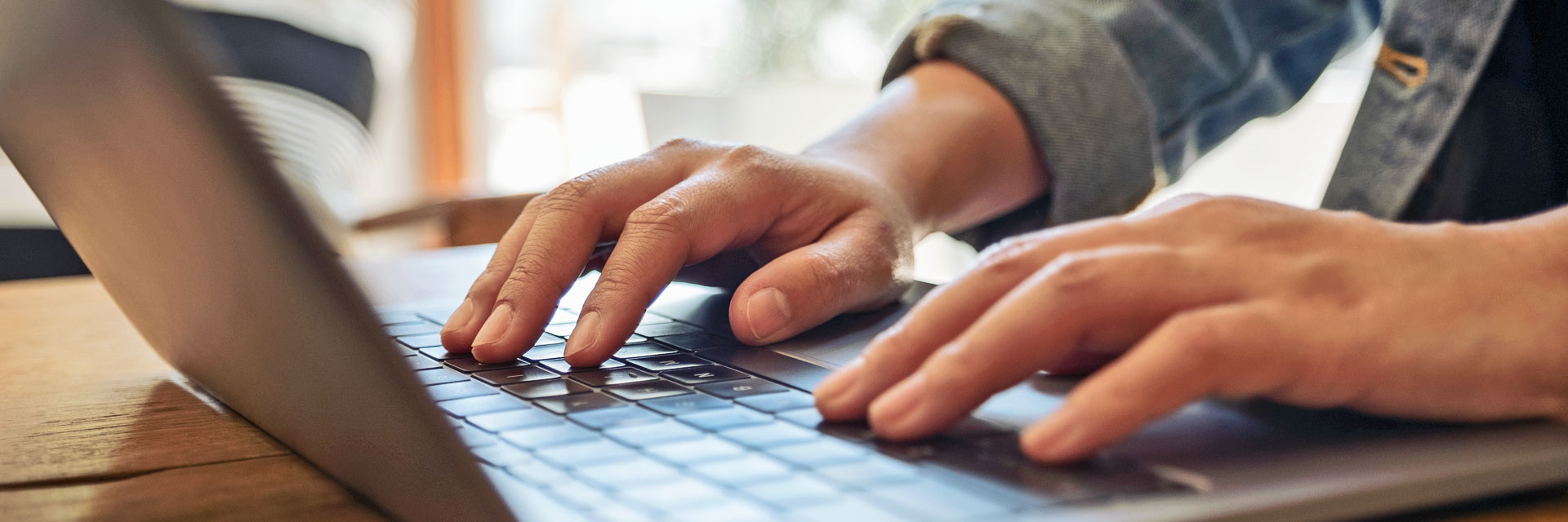 image of a man typing onto a computer keyboard